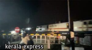 Kerala express crossing a rail road crossing in Palakkad Mankara