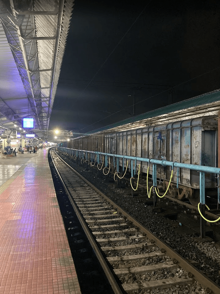 Palakkad Junction Railway Station in Kerala – view of platforms, electric locomotives, and surrounding greenery under the Western Ghats.